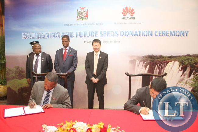 President Edgar Lungu and Huawei Senior Vice-President Dafeng Li witnessing the signing ceremony between Huawei Zambia managing director Fan Wen and Ministry of Energy representative Victor Mudenda at Shenzhen Wuzhou Guest House on April 1,2015 -Picture by THOMAS NSAMA