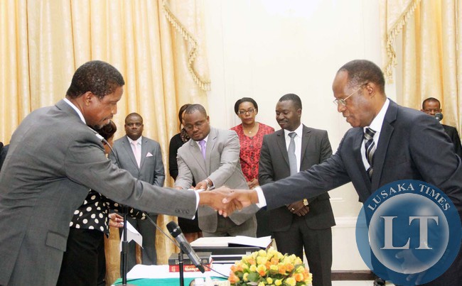 President Edgar Lungu congratultaes Newly appointed Chiefs and Traditional affairs Permanent Secretary Bernard Pwete (r) during the Swearing-In-Ceremony at State House on April 22,2015 -Picture by THOMAS NSAMA