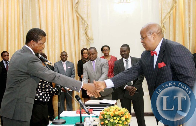 President Edgar Lungu congratulates Newly appointed Southern Province Permanent Secretary Sibanze Simuchoba during the Swearing-In-Ceremony at State House on April 22,2015 -Picture by THOMAS NSAMA