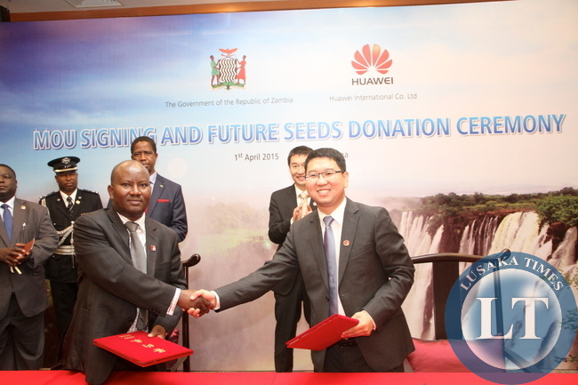 President Edgar Lungu and Huawei Senior Vice-President Dafeng Li witnessing the signing ceremony between Huawei Zambia managing director Fan Wen and Ministry of Energy representative Victor Mudende at Shenzhen Wuzhou Guest House on April 1,2015 -Picture by THOMAS NSAMA