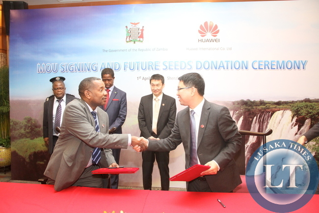 President Edgar Lungu and Huawei Senior Vice-President Dafeng Li witnessing the signing ceremony between Huawei Zambia managing director Fan Wen and Ministry of Energy representative Victor Mudenda at Shenzhen Wuzhou Guest House on April 1,2015 -Picture by THOMAS NSAMA