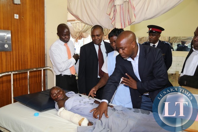 Lusaka Province Permanent Secretary Stardy Mwale talks to a 12years mazabuka accident victim Moffat Chipasha after visiting the Mazabuka and kafue accident victims at the University Teaching Hospital