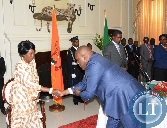 Vice President Inonge Wina congratulates Sukwana Lukaangaba the special assistant for legal Affairs to the President shortly after swearing in ceremony at State House