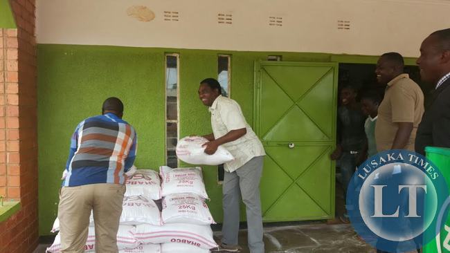 UPND President Hakainde Hichilema offload mealie meal at a shop in Linda compound