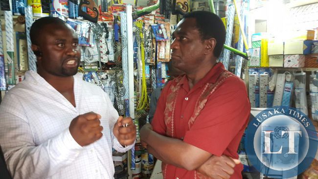 UPND president Hakainde Hichilema talks to business owner in Bauleni compound