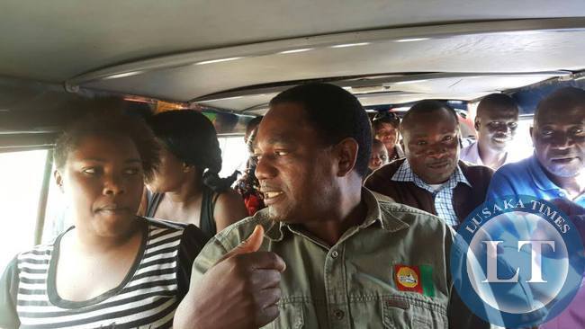UPND president Hakainde Hichilema interacts with passengers a minibus going to Mandevu