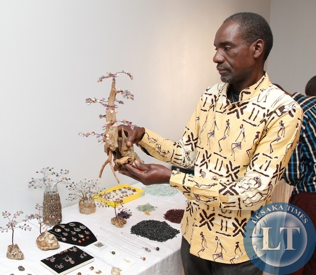 GEMOLOGIST Christopher Sikapizya explaining on the finished gamestone during the valuation additional programme for miners GEMOLOGIST Christopher Sikapizya explaining on the finished gamestone during the valuation additional programme for miners