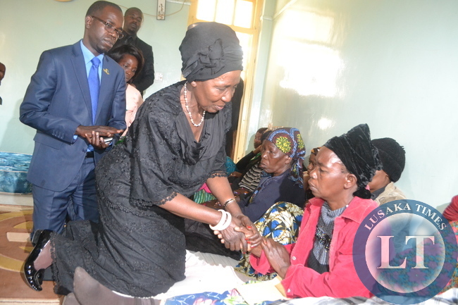 ACTING President Inonge Wina consoles the Mary Munthali, mother to Abel Munthali who is one of the deceased miners.