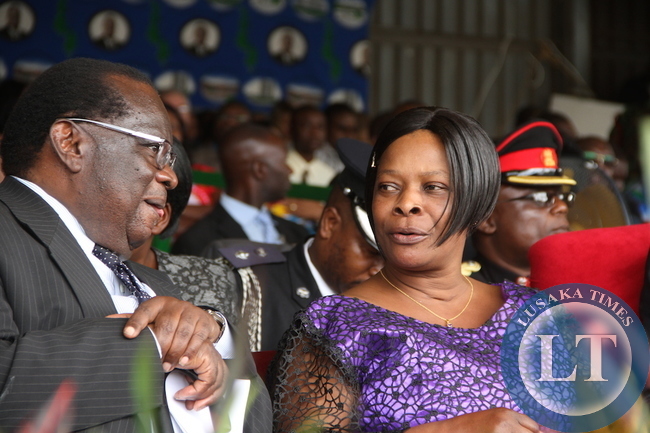 First Lady Esther Lungu speaks with Malawi's Finance minister Goodall Gondwe during Malawi's 51st Independence Celebrations at Kamuzu Stadium in Blantyre on July 6,2015 -Picture by THOMAS NSAMA