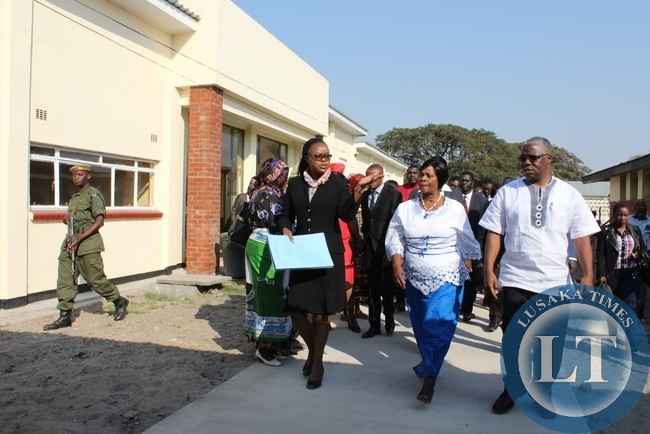 Lewanika General Hospital Superintendent Dr. Mapani Mutanga (l) leads First Lady Esther Lungu (c) and Mongu Central MP Nathanael Mubukwanu (r) through the tour of the hospital during the commissioning of a relatives’ shelter constructed with the support of the Ministers’ Wives Club in Mongu