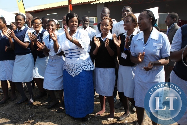 First Lady Esther Lungu (c) joins Lewanika School of Nursing Students in singing during the commissioning of a relatives’ shelter constructed with the support of the Ministers’ Wives Club in Mongu