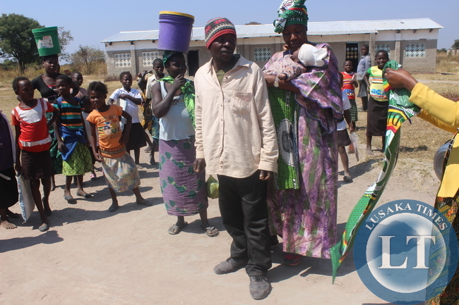 President Nawakwi gives a party chitenge to a father who had taken his child for under five at Kaishe.