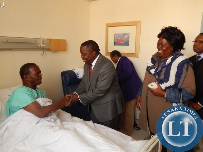 : L-R - FOREIGN Affairs Minister, Mr. Harry Kalaba shakes hands with Archbishop Telesphore Mpundu. Looking on is Tourism and Arts Minister, Ms. Jean Kapata, and out-going Zambia's High Commissioner to South Africa, His Excellency Mr. Muyeba Chikonde. This was during a visit to see the Archbishop at Milpark Hospital in Johannesburg