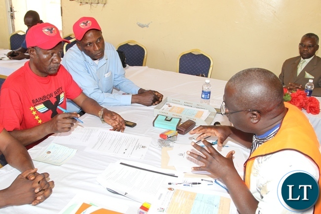 2 rainbow Rainbow candidate Daniel Mubanga flash party symbol whilst party official Robert Chikwelete accompany the candidate to drum up support during the filling in of nomination for Lubanseshi constituency Luwingu District Council