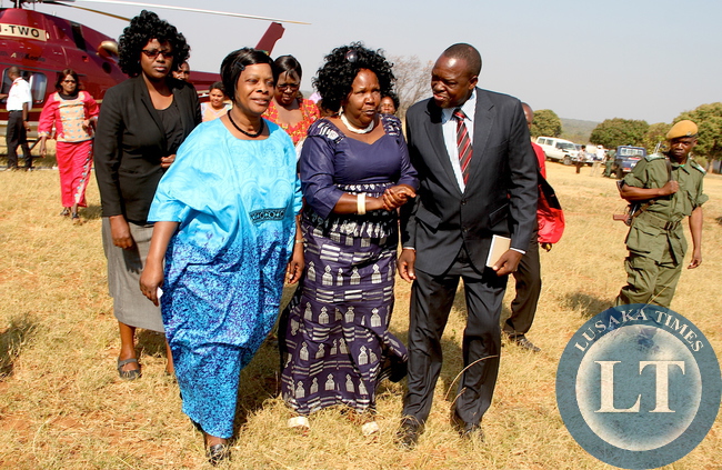 First Lady Esther Lungu flanked by Community Development , Mother and Child Health Deputy minister Josphine Limata (C) and Kaoma District Commissioner Robert Chiseke (r) on arrival at Mutondo Basic School for the Outreach Programme for People with Special needs in Mangango, Western Province on Monday, August 17,2015 -Picture by THOMAS NSAMA/STATE HOUSE