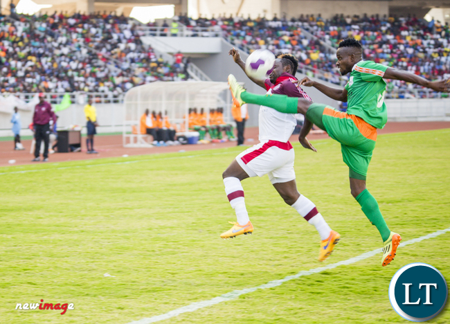 Nkana striker Jimmy Ndhlovu (l) battles for the ball with Zesco United defender Ayo Oluwafemi (r).