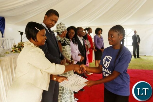 First Lady Esther Lungu (left) and President Edgar Chagwa Lungu (second from left) presents a certificate to Kunda Chomba (right) from Mupepetwe Secondary School in Central Province after she participated in the First Lady Mentorship Program at State House on Monday, August 10,2015. PICTURE BY SALIM HENRY/STATE HOUSE © 2015