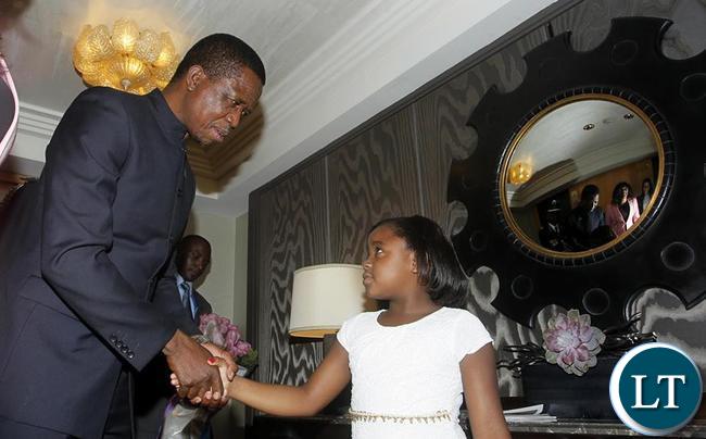 President Edgar Chagwa Lungu (left) greets eight year old Vanessa Brown Mwanza at Palace Hotel in New York on Thursday,September 24,2015. PICTURE BY SALIM HENRY/STATE HOUSE ©2015