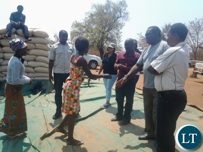 Food Reserve Agency executive director Chola Kafwabulula greeting Chankhanga clerk Hope Mwape in Chipata