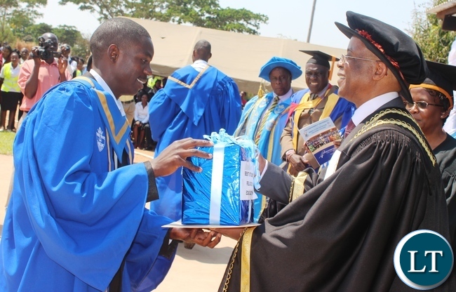 Students raise their diplomas during the Immaculata Teachers College fourth graduation ceremony in Kabwe