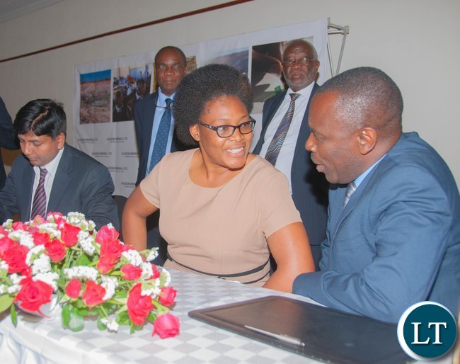 Kagem Head of Human Resources Gibson Banda signs a pension agreement with Saturnia Regna Director of Business Development Collina Halwampa, weatched by Labour Minister Hon. Fackson Shamenda and Kagem Director Dr Sixtus Mulenga. Kagem Head of Human Resources Gibson Banda signs a pension agreement with Saturnia Regna Director of Business Development Collina Halwampa, weatched by Labour Minister Hon. Fackson Shamenda and Kagem Director Dr Sixtus Mulenga.