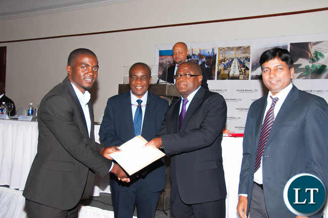 Mines Minister Hon. Christopher Yaluma presents a certificate in recognition of Kagem’s record injury-free shifts, watched by Kagem Director Dr Sixtus Mulenga and General Manager Dibya Baral