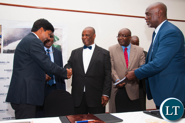 Education Minister Hon. Michael Kaingu congratulates Kagem General Manager Dibya Baral on signing of an MOU scholarship agreement with the Univeristy of Zambia and Copperbelt University.