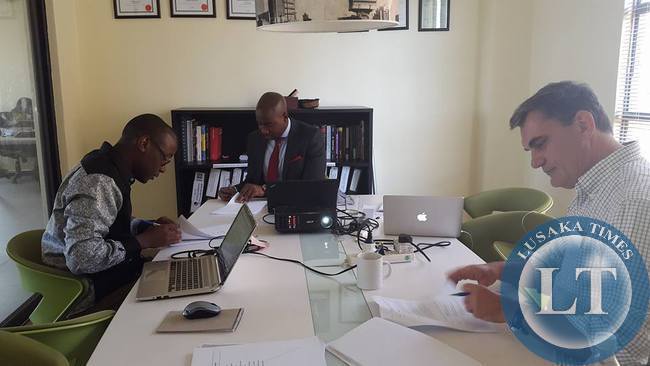 Dot Com Zambia CEO , Mawano Kambeu (l) with Jito Kayumba (c) Managing Partner at Kukula Capital and Vincent Kouwenhoven (r) Managing Director of eVentures Africa Fund signing the investment agreement
