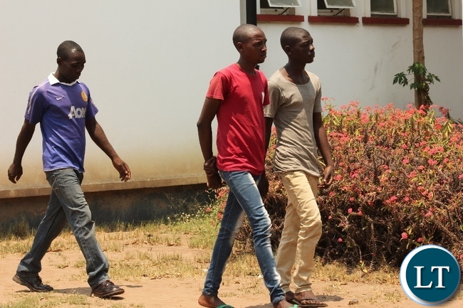 Hatch Bril (c) arrives at Mongu Magistrate Court for trial facing sodomy charges yesterday. Hatch is 27 years old, a hair dresser in Mongu and all along has been portraying as a woman hence deceiving men to fall for him.