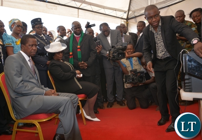 President Edgar Lungu and his wife Esther being shown the plan of the church by an architecture and designer Jimmy Sinyangwe during the ground breaking ceremony for new cathedral and interdenominational thanksgiving church service for Zambias 51st independence anniversary yesterday, 25-10-2015. Picture by Ennie Kishiki/ZANIS.