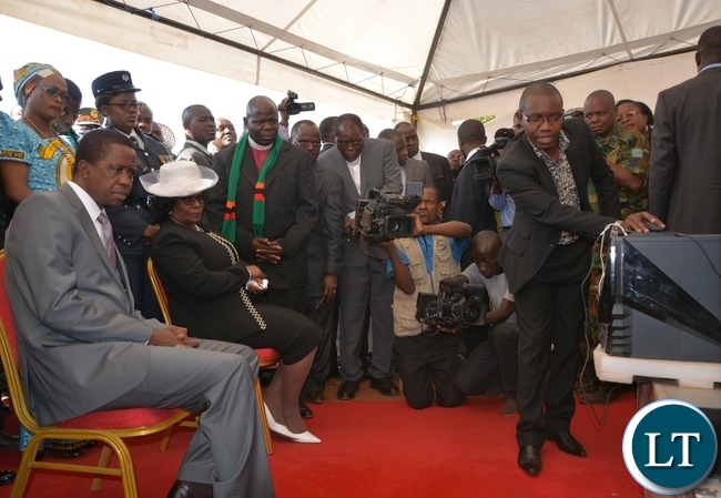 President Edgar Lungu and his wife Esther being shown the plan of the church by an architecture and designer Jimmy Sinyangwe during the ground breaking ceremony for new cathedral and interdenominational thanksgiving church service for Zambias 51st independence anniversary yesterday, 25-10-2015. Picture by Ennie Kishiki/ZANIS.