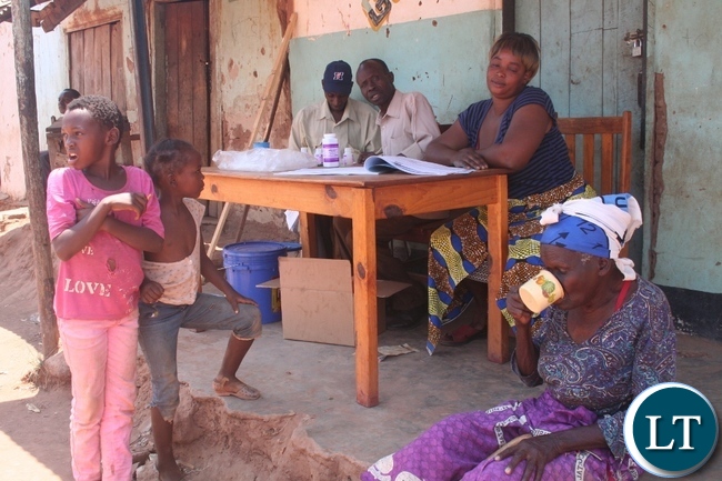 Ministry of Health in partnership with Orbis through the sponsorship of Standard Chartered Bank under its seeing is believing Initiative (Sib) is administering mass eye drugs to the communities in Kasempa to eliminate Trachoma. ABOVE, 79 year old Tumela Shonji ( r ) of Muselepete compound taking the drug as her grand children Clara (l) and Hellen Kalube and community drug distributors look on in Kasempa Ministry of Health in partnership with Orbis through the sponsorship of Standard Chartered Bank under its seeing is believing Initiative (Sib) is administering mass eye drugs to the communities in Kasempa to eliminate Trachoma. ABOVE, 79 year old Tumela Shonji ( r ) of Muselepete compound taking the drug as her grand children Clara (l) and Hellen Kalube and community drug distributors look on in Kasempa