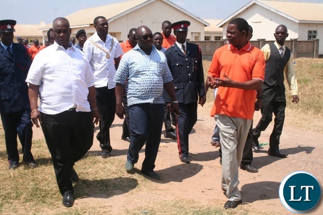 Higher education minister Dr Michael Kaingu (l) with North-Western province permanent secretary Amos Malupenga (m) listen to an explanation from Solwezi Trades principal Edmond Kambobe during the tour of the learning institution