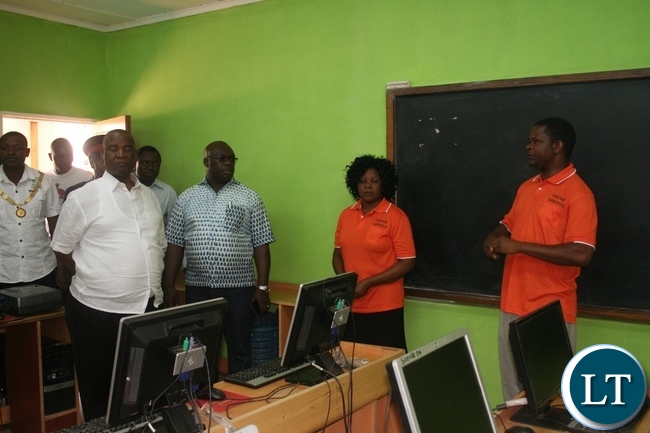Higher education minister Dr Michael Kaingu (l) seated with North-Western province permanent secretary Amos Malupenga (second left) listen to Solwezi Trades principal Edmond Kambobe during the tour of the ICT laboratory at the learning institution .Looking on the right is Head-ICT Naomi Phiri