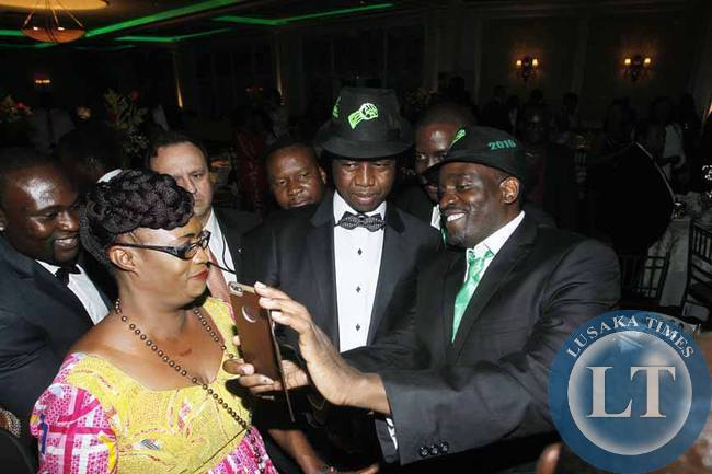President Edgar Chagwa Lungu (second from right) and Patriotic Front Deputy Secretary General Mumbi Phiri photographed using a selfie by Francis Malama (right) during the USA-PF Fundraising at Davenport Country Club in New York, United States of America on Friday, September 25,2015. PICTURE BY SALIM HENRY/STATE HOUSE ©2015