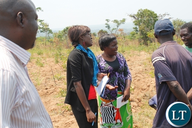 Monitoring team lead by Mbala DAO Felix Mungaila (l) listening to Mr. Edward silunjili fish farmer (in green t- shirt) how he is managing the finger lings