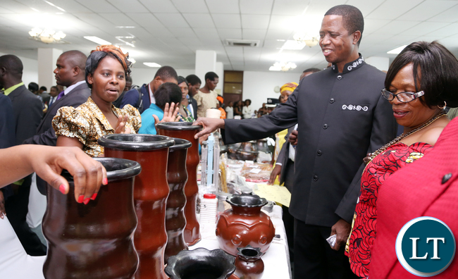 President Edgar Lungu talks to Gladys Mpungu and Matildah Kasonde of Rainbow Sovew shoes of Luansya during the exhibition at Mulungushi confrence Centre for the National Women Economic Empowerment Expo, which was Promoting Young Women enterpreneurs as a Change agents for National development . Picture By Eddie Mwanaleza/ Statehouse. 13-10-2015.