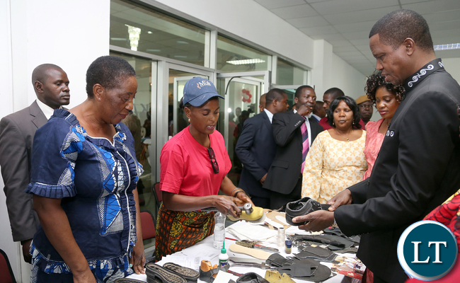 President Edgar Lungu talks to Gladys Mpungu and Matildah Kasonde of Rainbow Sovew shoes of Luansya during the exhibition at Mulungushi confrence Centre for the National Women Economic Empowerment Expo, which was Promoting Young Women enterpreneurs as a Change agents for National development . Picture By Eddie Mwanaleza/ Statehouse. 13-10-2015.