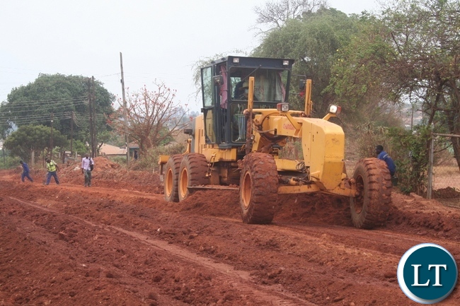 Government recently contracted China Geo Engineering company to upgrade 20.5 kilometers of selected Solwezi urban roads to bituminous standard at a total cost of K220 million. Above, a grader mixes a road in readness for compact on Mushindamo street in Solwezi Government recently contracted China Geo Engineering company to upgrade 20.5 kilometers of selected Solwezi urban roads to bituminous standard at a total cost of K220 million. Above, a grader mixes a road in readness for compact on Mushindamo street in Solwezi