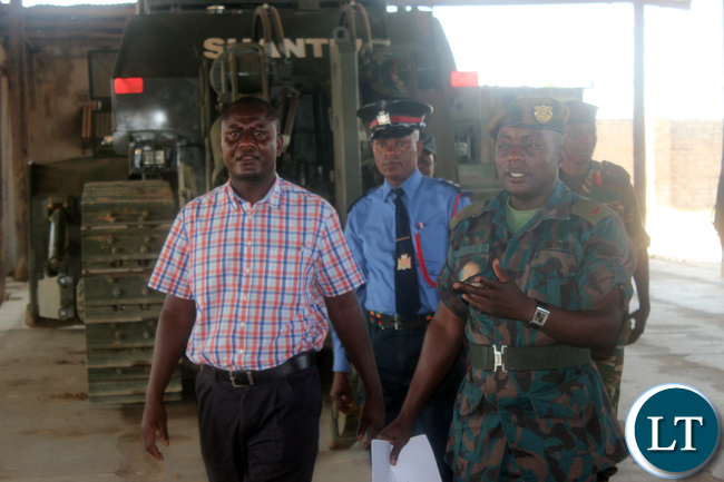 Central Province Minister Davies Chisopa (in civil ) inspecting the newly acquired equipment to be working on the roads in Central province