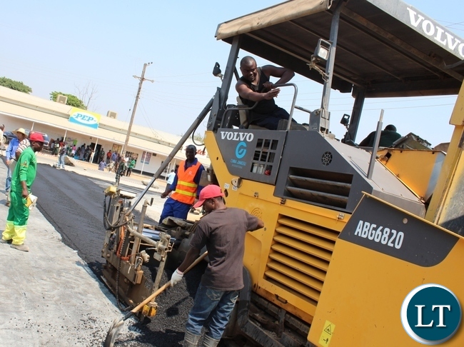 construction of township roads in Serenje District advances: A Contractor working on Serenje township roads China Jiangsu, paving one of the roads under construction in the district. construction of township roads in Serenje District advances: A Contractor working on Serenje township roads China Jiangsu, paving one of the roads under construction in the district.