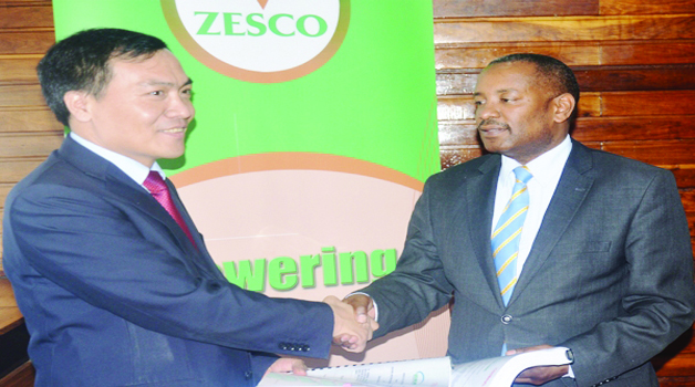 ZESCO acting managing director Victor Mundende (right) exchanges documents with Sinohydro Corporation Limited vice-president Liu Kai. This was during the signing of a contract for the construction of the Kafue Gorge Lower hydro power plant.
