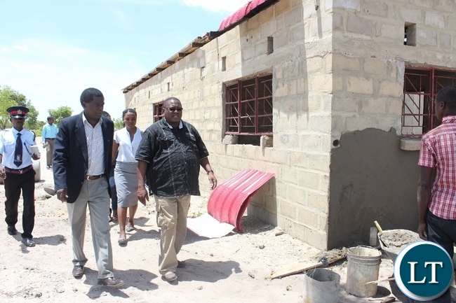 Adastra Fruit Juice Processing proprietor Noyoo Ikanuke (r) leads Mongu District Commissioner Susiku Kamona (l) around his mango processing plant which is still under construction in Mongu yesterday. Government is inspecting the progress on projects funded by Citizens Economic Empowerment Commission (CEEC) in the district.