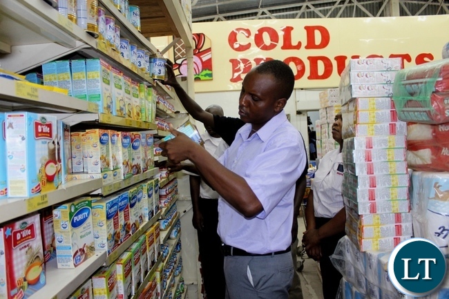 Western Provincial Competition and Consumer Protection Commission (CCPC) Investigator Mutemwa Nakambowa (c) checking the expiring date on baby products in Shoprite during an Inspection and Sensitization Tour to Traders to observe the CCPC Act in Mongu Western Provincial Competition and Consumer Protection Commission (CCPC) Investigator Mutemwa Nakambowa (c) checking the expiring date on baby products in Shoprite during an Inspection and Sensitization Tour to Traders to observe the CCPC Act in Mongu