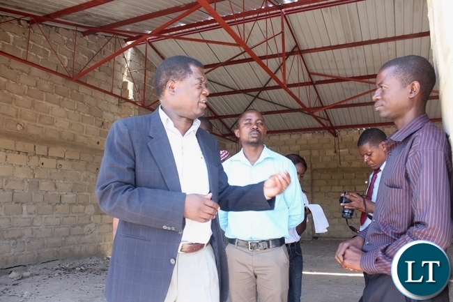 Mongu District Commissioner Susiku Kamona (l) confers with Tusano Mango Processor CEO Mwisiya Waluka (r) during the inspection of work progress on projects funded by Citizens Economic Empowerment Commission (CEEC) in Mongu Mongu District Commissioner Susiku Kamona (l) confers with Tusano Mango Processor CEO Mwisiya Waluka (r) during the inspection of work progress on projects funded by Citizens Economic Empowerment Commission (CEEC) in Mongu