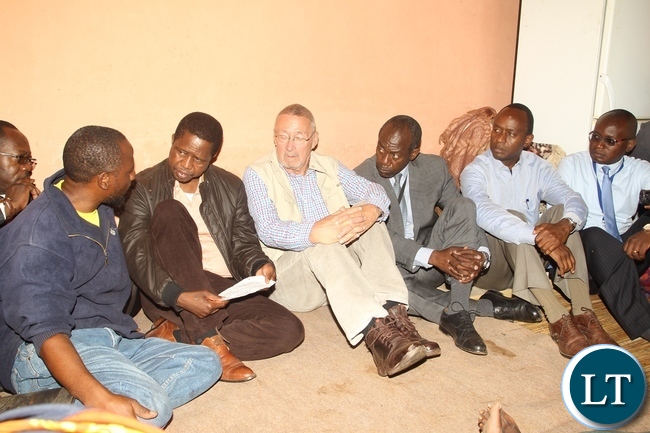 President Edgar Lungu comforting Mike Banda (L) one of the relative deceased Fades Banda the President who is accompany with his Special Assistant for Press and Public Relations Amos Chanda (r), State House Deputy Minister Mulenga Sata (2nr), DMMU Coordinator Patrick Kangwa (3rd r) and PF Lusaka Central Member of Parliament Guy Scot during the tour of the affected Houses in Baulini