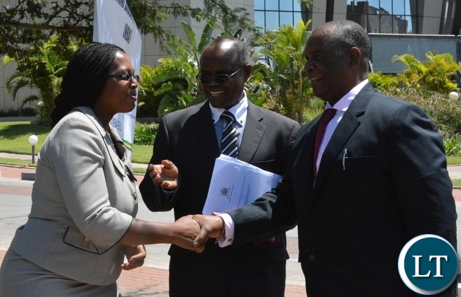 Higher Education Minister Micheal Kaingu being welcomed by the Director of science and technology in the ministry of higher education Jane Chinkusu while National Biosafety Authority Board Chairman Paul Zambezi looks on,this was during the launch of National Biosafety Authority