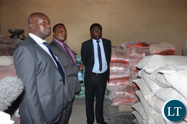 Mongu District Commissioner Susiku Kamona (r) with Mongu District Agriculture Officer Ng’ambiChabalanga (c) and Western Provincial Agriculture Officer Alex Chilala (l) inside the warehouse inspecting farmers imputes during the launch of the 2015/2016 farmers Impute Support Programe (FISP) in Mongu