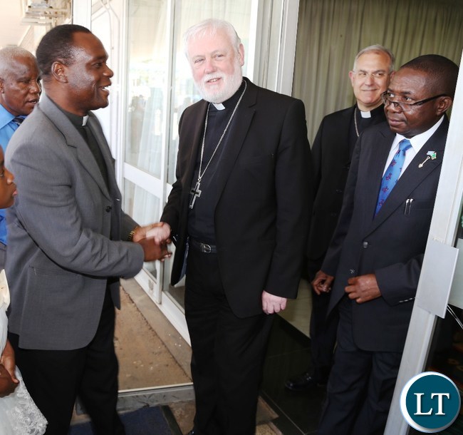 ZEC National Pastoral Coordinator Fr. Justin Matepa welcomesHis excellency Mgrs.Poul Richard Gallgher (L) flanked by Foreign Affairs Deputy Minister Reyford Mbulu (r) at Kenneth Kaunda International Airport yesterday 07-11-2015. Picture by ROYD SIBAJENE/ZANIS