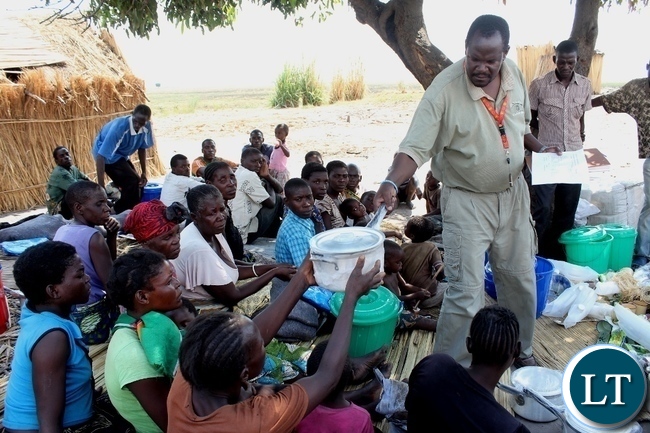DMMU District Secretary Matakala Mbangweta (r) distributing kitchen utensils to disaster victims of a firestorm which burnt the entire Imuba Village to ashes in Lower Katongo area in Mongu. DMMU District Secretary Matakala Mbangweta (r) distributing kitchen utensils to disaster victims of a firestorm which burnt the entire Imuba Village to ashes in Lower Katongo area in Mongu.